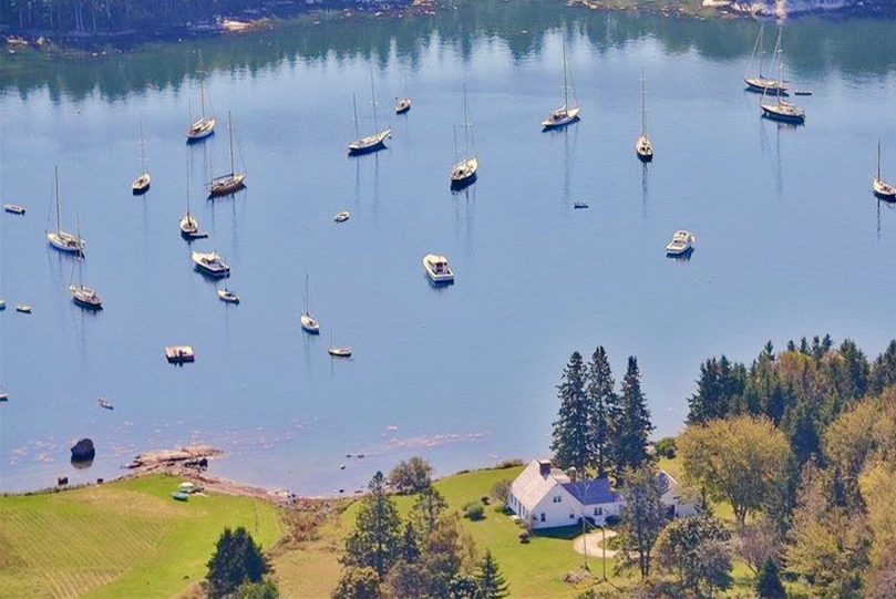 aerial view of the house and the harbor with sailboats